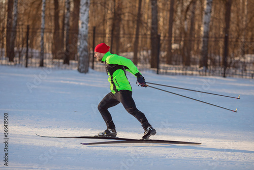 Cross country skiing in winter on snowy track, sunset background, habits for healthy lifestyle