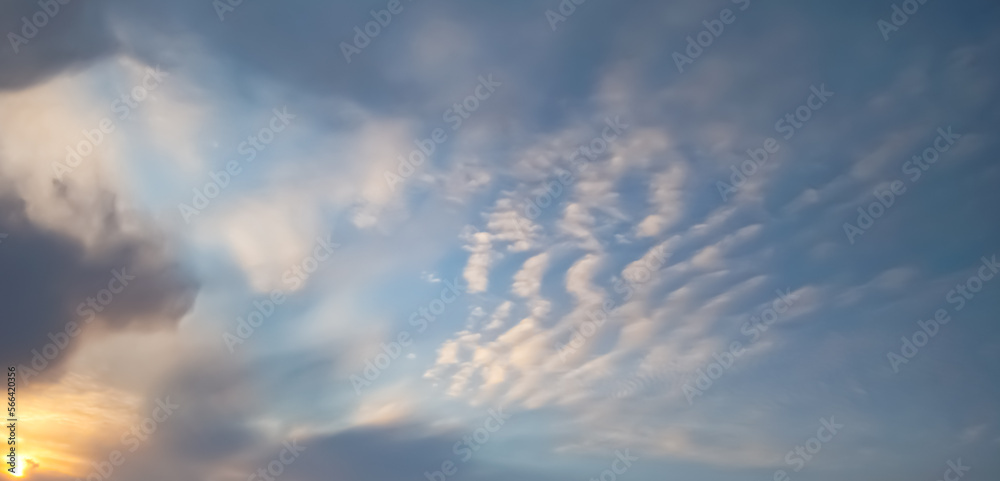 Minimalistic sky with cirrus clouds and clouds at sunset, evening cloudy sky