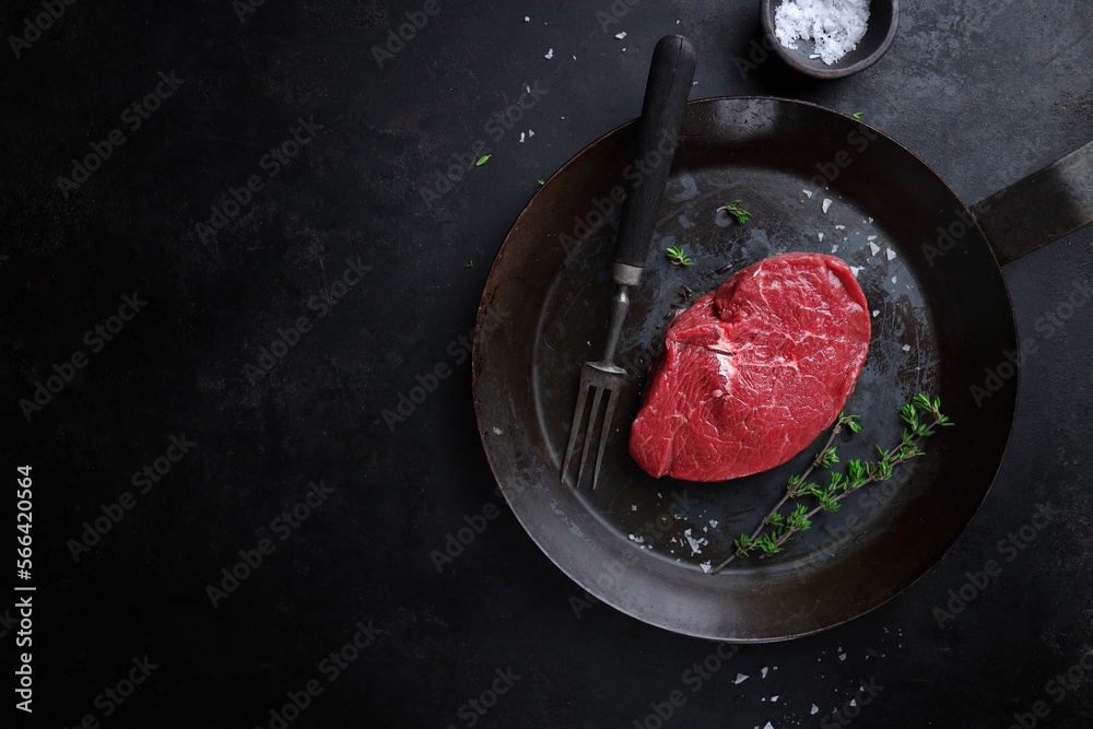 Raw meat with spices and herbs on table Raw meat with spices and herbs on table