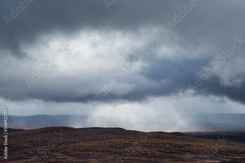 Rain falling over autumn landscape in VindelfjÃ¤llen Nature Reserve, Kungsleden trail, Lapland, Sweden photo