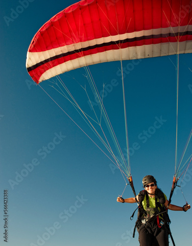 A young woman launching her paraglider in Santa Barbara, CA. photo