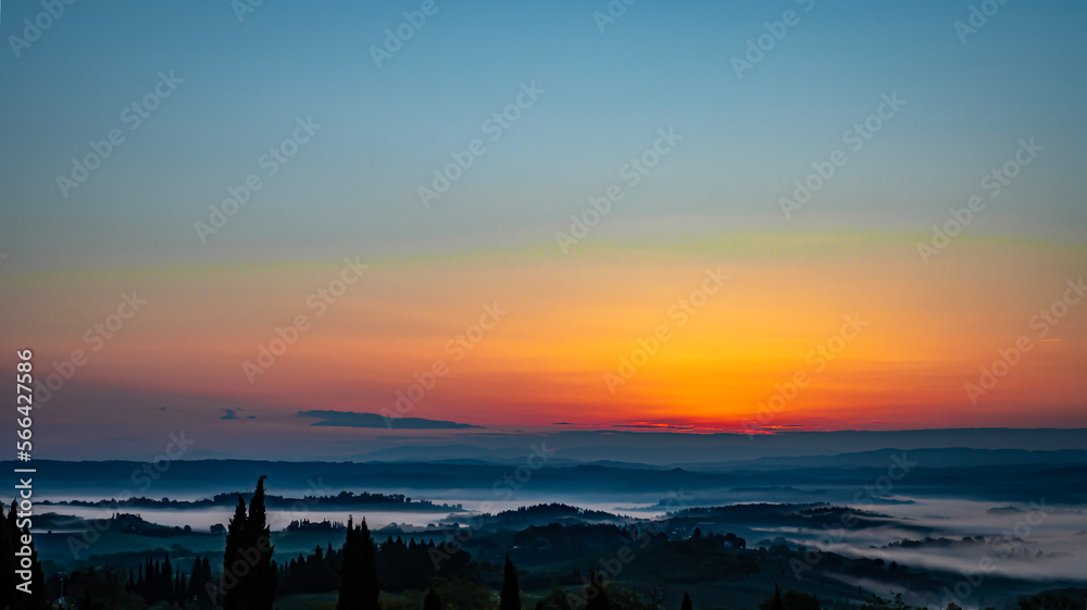 hazy sunrise over Tuscany