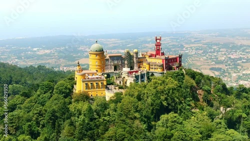 Aerial drone view of Pena Palace, Castle in Sintra, Portugal. Famous day trip tour from Lisbon. Summer in Europe travel, historic tourism destination. photo
