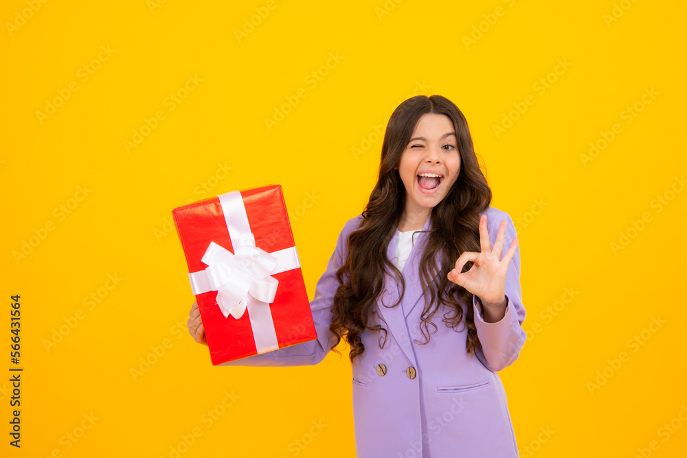 Amazed teen girl. Teenager kid with present box. Teen girl giving birthday gift. Present, greeting and gifting concept. Excited expression, cheerful and glad.