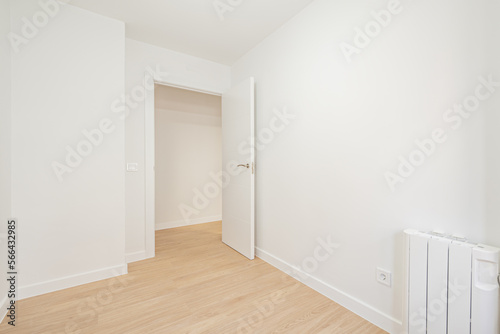 Empty room painted white with woodwork of the same color