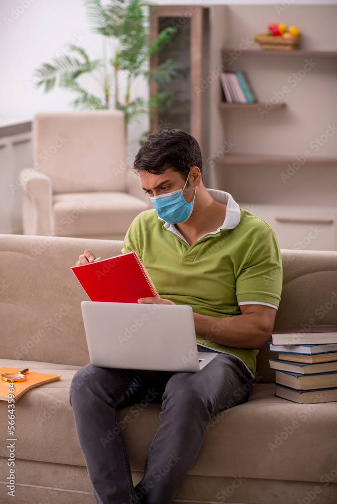 Young male student preparing for exams at home during pandemic Young male student preparing for exams at home during pandemic