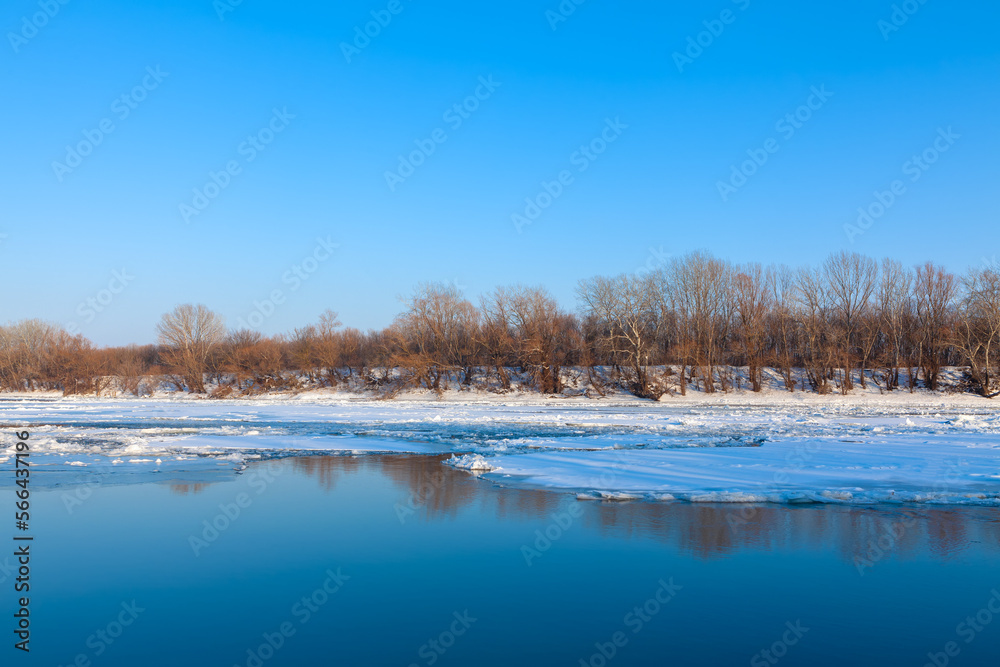 Ice melting on surface of frozen river . Springtime with ice on the water 