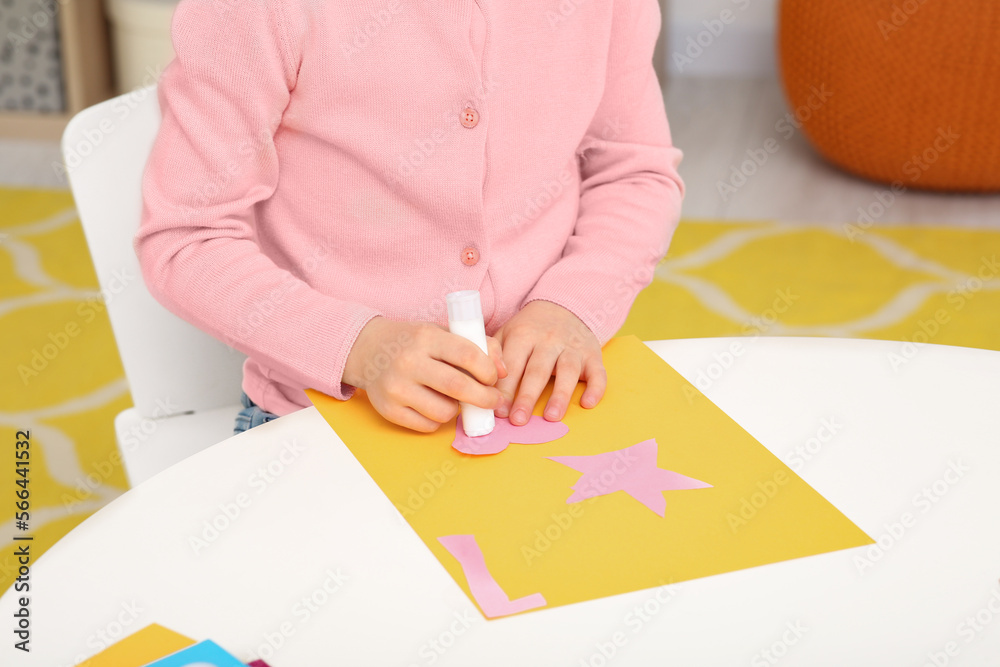 Girl using glue stick at desk in room, closeup. Home workplace Girl using glue stick at desk in room, closeup. Home workplace
