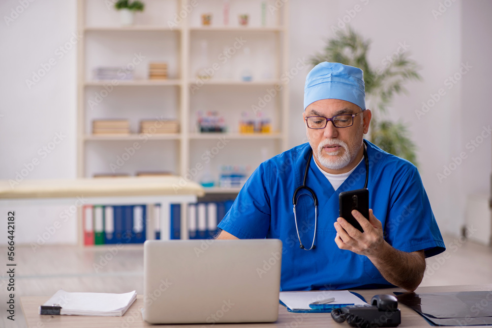 Old male doctor in telemedicine concept Old male doctor in telemedicine concept