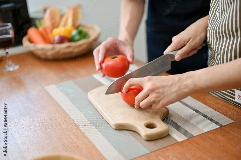Close-up image of lovely couple cooking their breakfast together in the kitchen Close-up image of lovely couple cooking their breakfast together in the kitchen