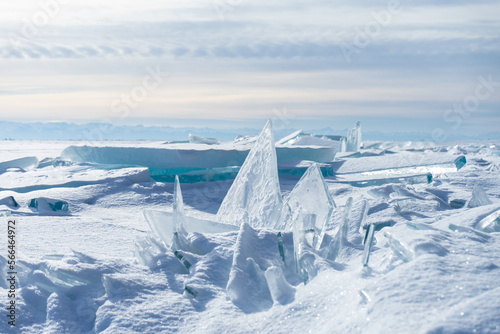 Winter sea day. Chunks of blue ice. Panoramic view of the snow-covered shore of the frozen sea  the lake on a winter  spring day. Shards of ice close-up. Christmas  seasons  winter.  Selective focus.