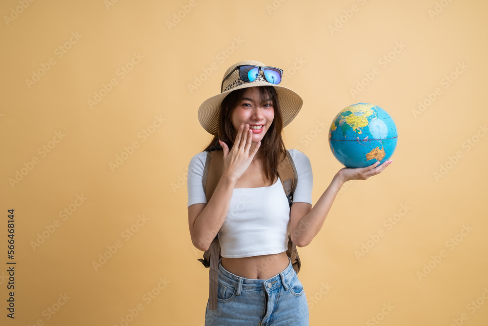 young attractive Asian woman traveler in casual clothes wearing straw hat with sunglasses and backpack holding a globe in her hands, Tourist girl having cheerful holiday trip concept young attractive Asian woman traveler in casual clothes wearing straw hat with sunglasses and backpack holding a globe in her hands, Tourist girl having cheerful holiday trip concept