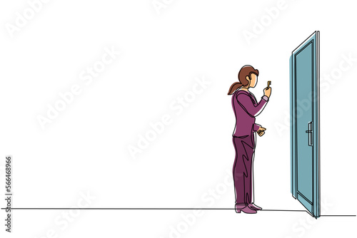 Single continuous line drawing businesswoman lifts key in front of door. Woman holding key to open office room door. Starting morning with spirit to work. One line graphic design vector illustration
