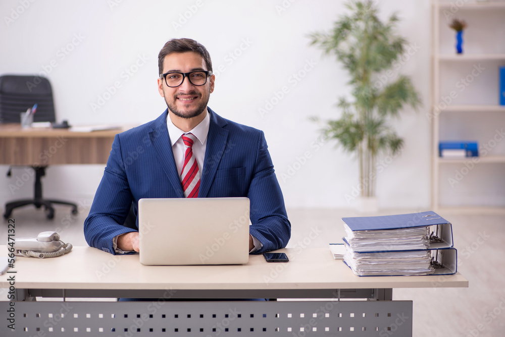 Young male employee working in the office