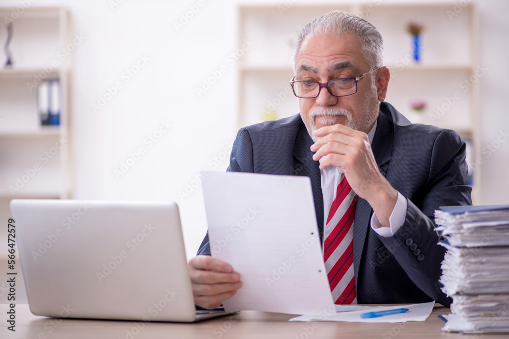 Old male employee and too much work in the office Old male employee and too much work in the office