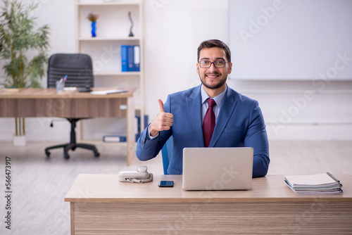 Young male employee working in the office