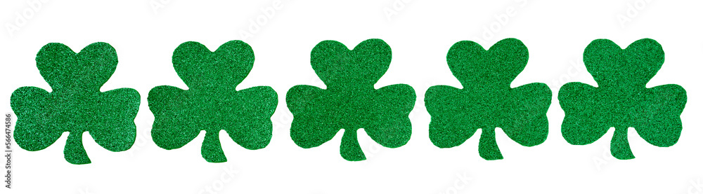 Fototapeta premium Row of green glitter shamrocks isolated on a transparent background, happy St. Patrick’s Day 
