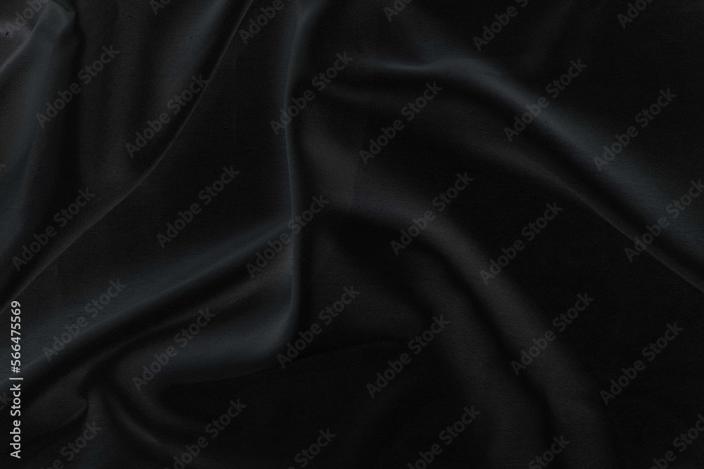Smooth elegant black silk fabric or satin luxury cloth texture for abstract background