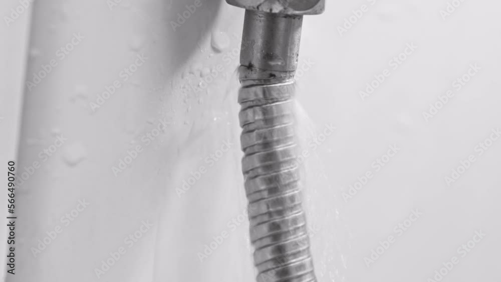 water is flowing from a broken shower hose. water is flowing from a broken shower hose.