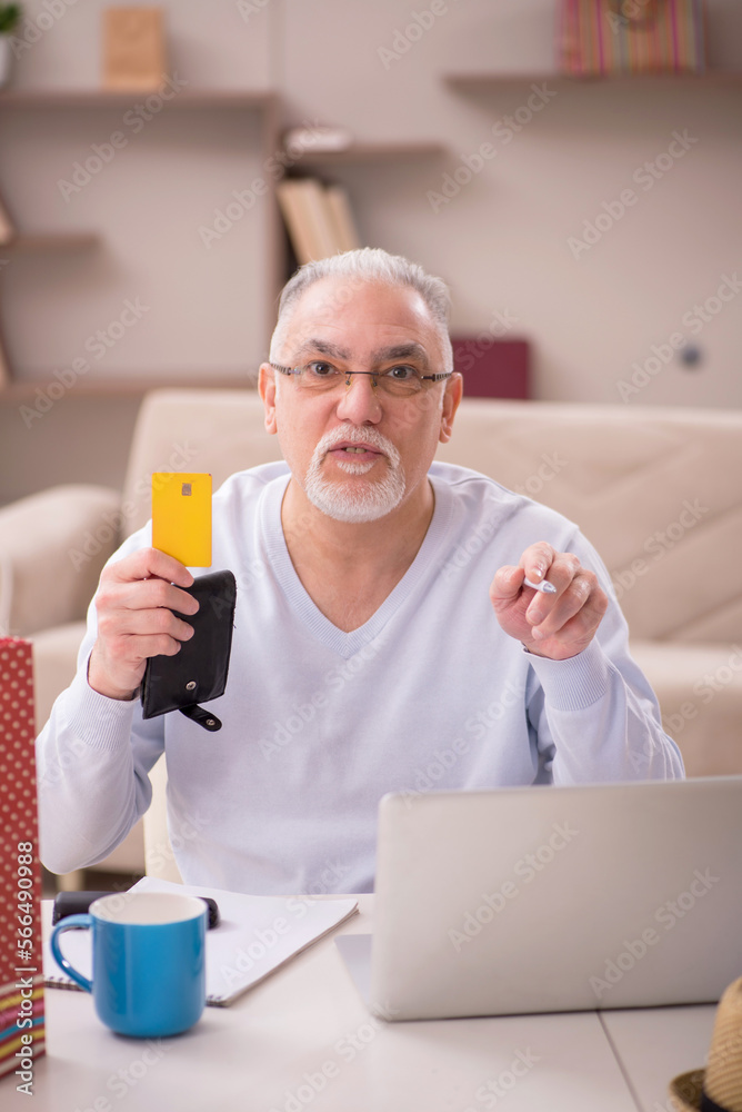 Old man with many bags in Christmas concept at home Old man with many bags in Christmas concept at home