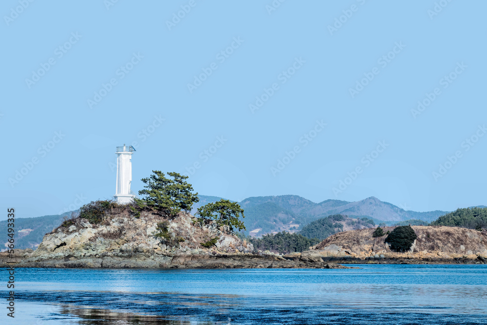 White lighthouse on small island