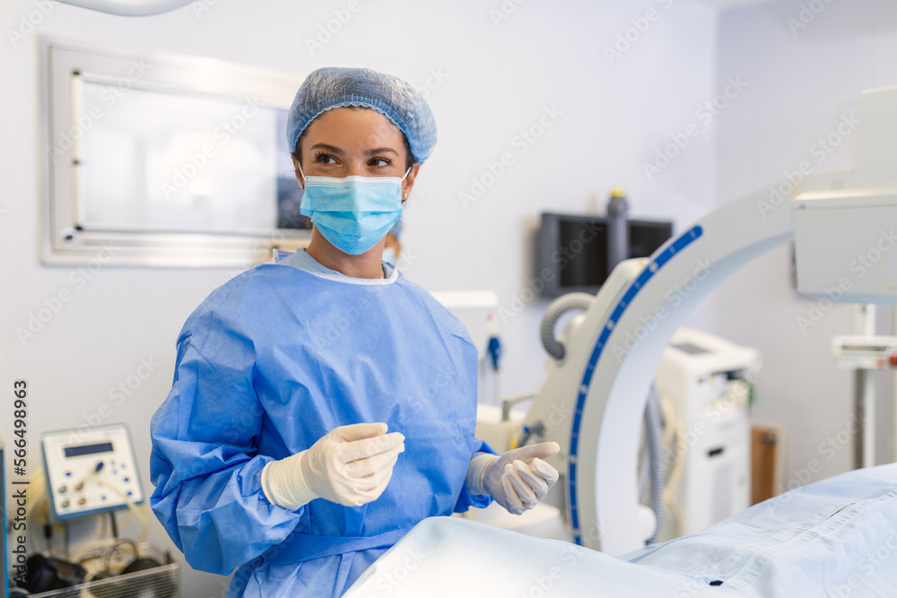 Female surgeon with surgical mask at operating room using 3d image guided surgery machine Female surgeon with surgical mask at operating room using 3d image guided surgery machine