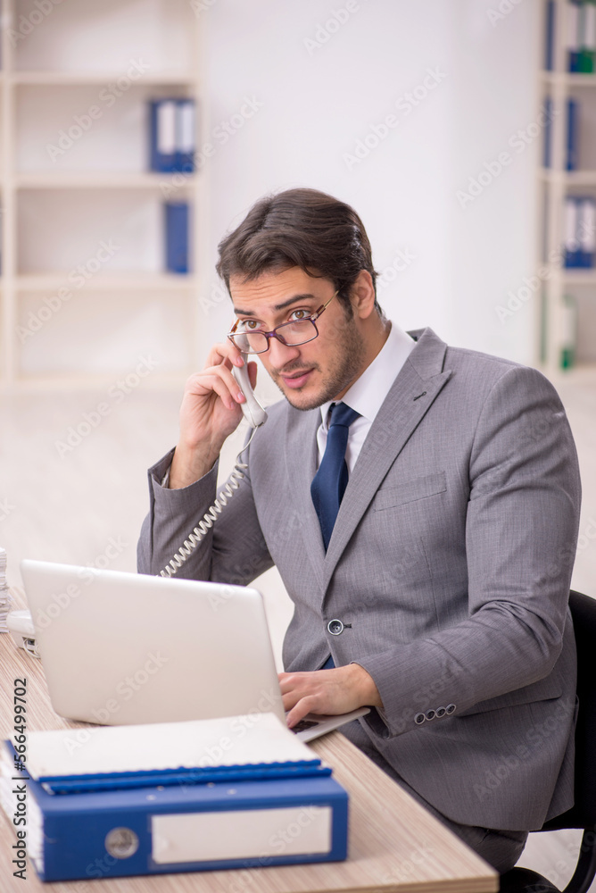 Young male employee working in the office Young male employee working in the office