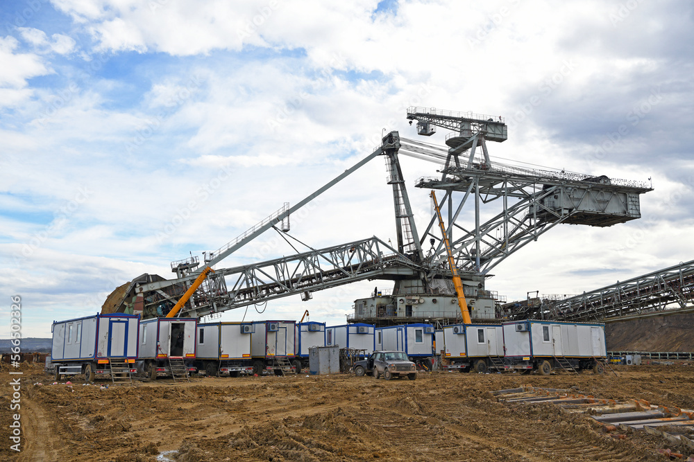 Bucket-wheel excavator during excavation at the surface mine. Huge excavator on open pit mine.