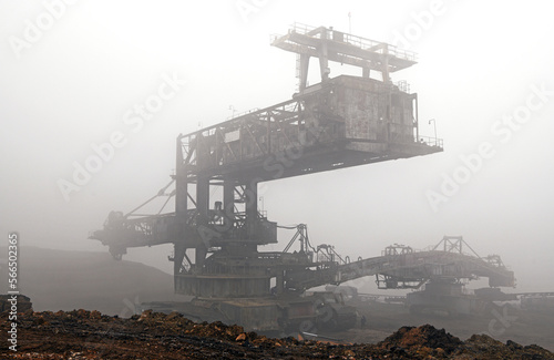 Bucket-wheel excavator during excavation at the surface mine. Huge excavator on open pit mine.