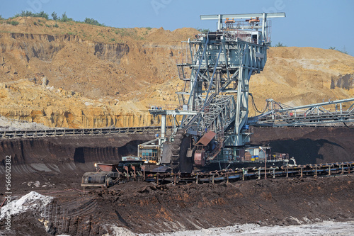 Bucket-wheel excavator during excavation at the surface mine. Huge excavator on open pit mine.