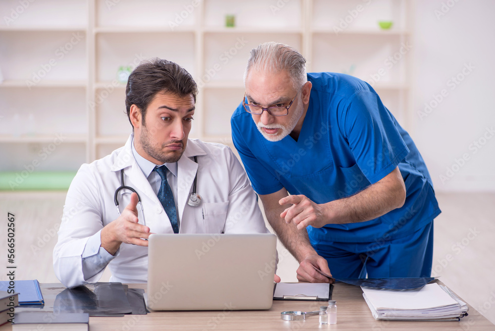 Two male doctors in telemedicine concept Two male doctors in telemedicine concept
