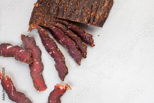Freshly cut South African biltong on light background with selective focus and copy space.