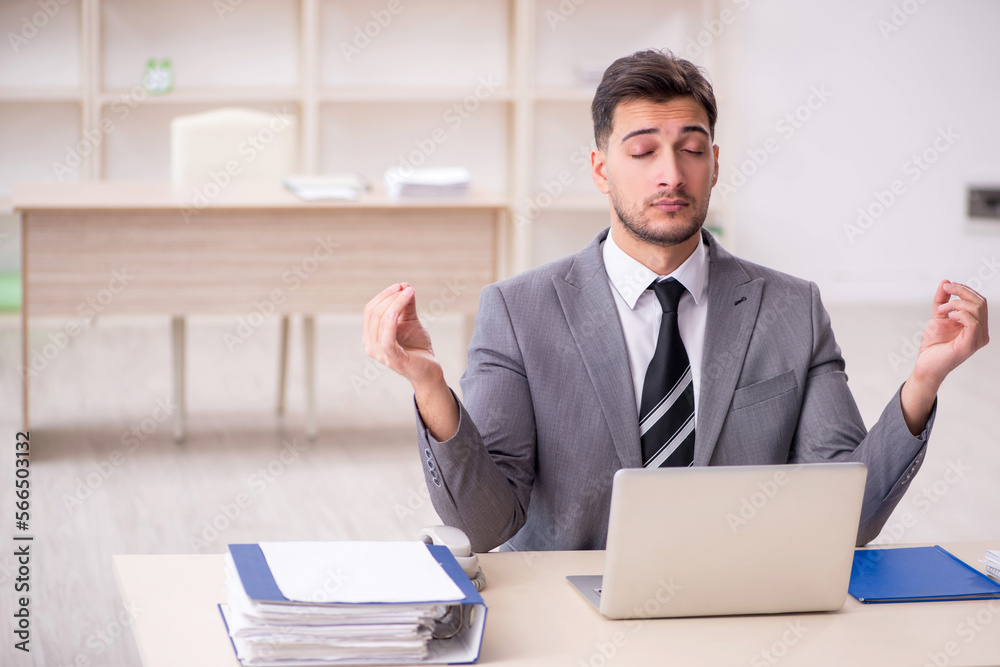 Young male employee working in the office Young male employee working in the office