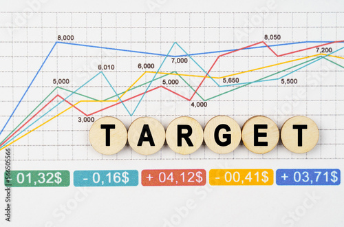 On the financial charts are wooden mugs with the inscription - TARGET