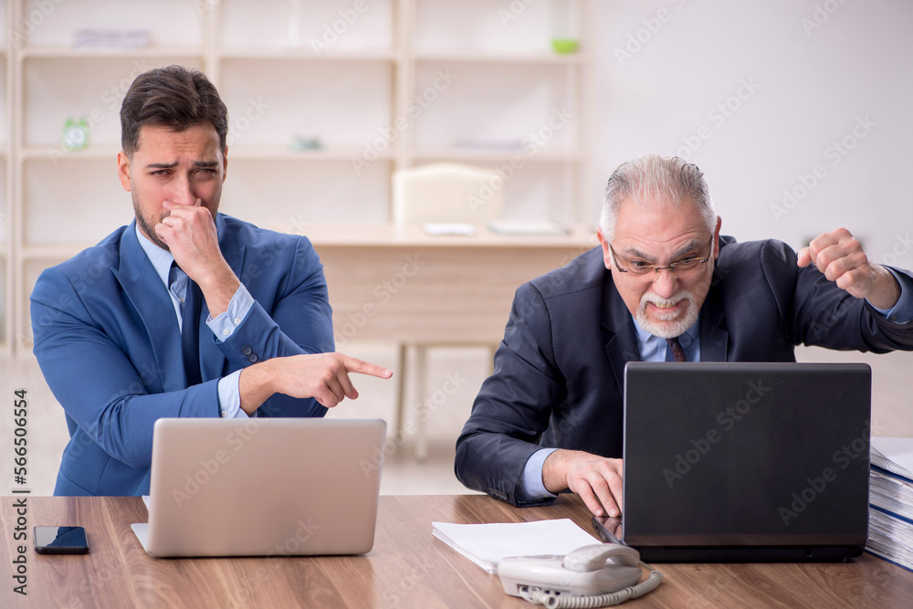 Two male employees working in the office Two male employees working in the office