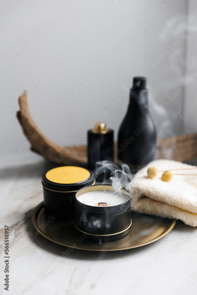 Soy scented candles in metal tins, boxes. Candles on a metal tray. in