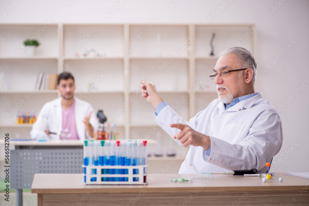 Two male chemists working at the lab Two male chemists working at the lab