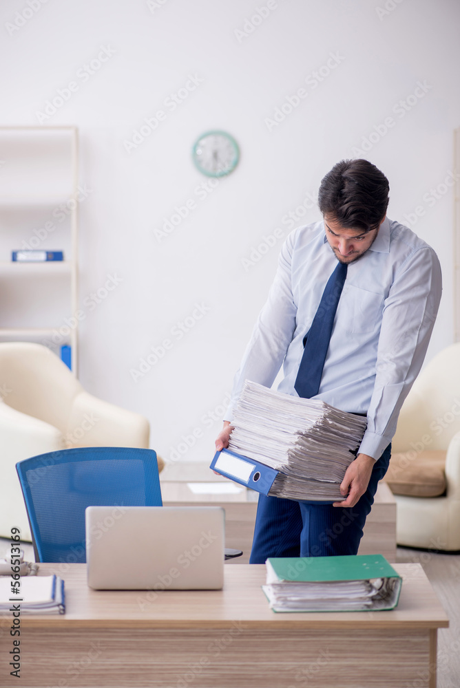 Young male employee working in the office Young male employee working in the office