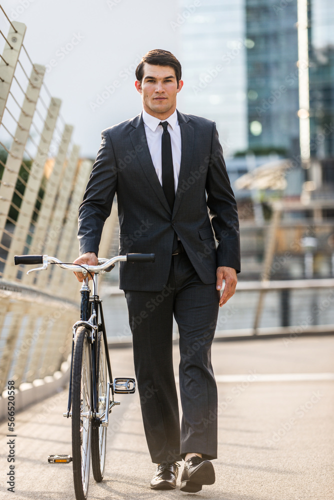 Young handsome man with business suit driving bicicyle to go to office - Corporate businessman portrait biking in the city, concepts about business, green mobility and lifestyle Young handsome man with business suit driving bicicyle to go to office - Corporate businessman portrait biking in the city, concepts about business, green mobility and lifestyle