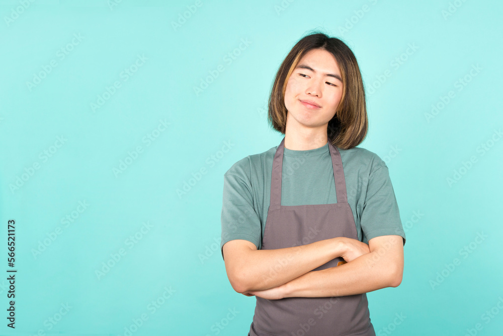 Asian man with apron smiling while crossing arms Asian man with apron smiling while crossing arms