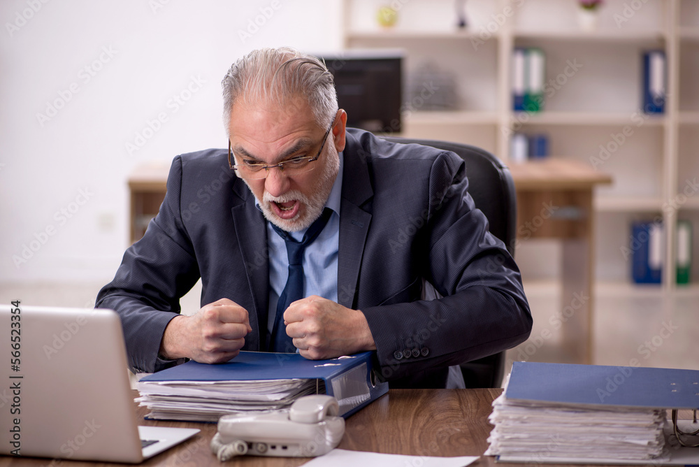 Old male employee and too much work in the office Old male employee and too much work in the office