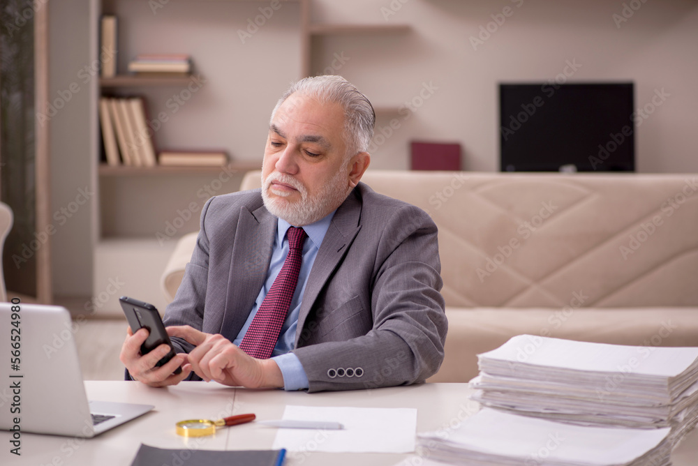 Fototapeta premium Old male employee working from home during pandemic