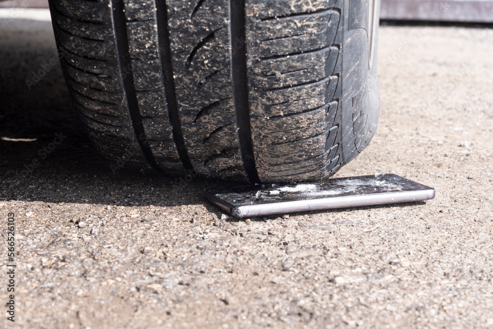 The car hit the phone. The wheel of the car was driving the phone. The car hit the phone. The wheel of the car was driving the phone.