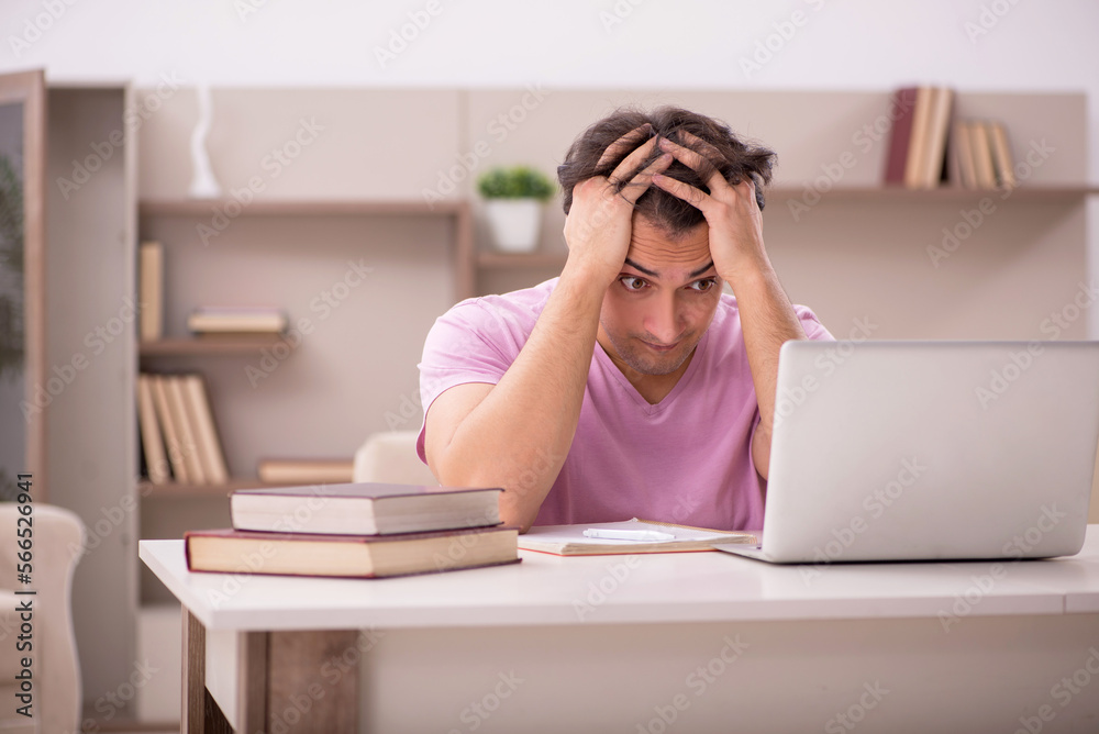 Young male student preparing for exams at home Young male student preparing for exams at home