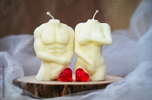 Soy handmade candles and two red hearts. Man and woman. Nude figures of male and female bodies. Relationships intimacy concept. Symbol of love. Valentine's Day