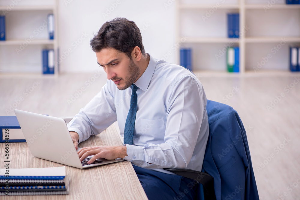 Young male employee working in the office Young male employee working in the office