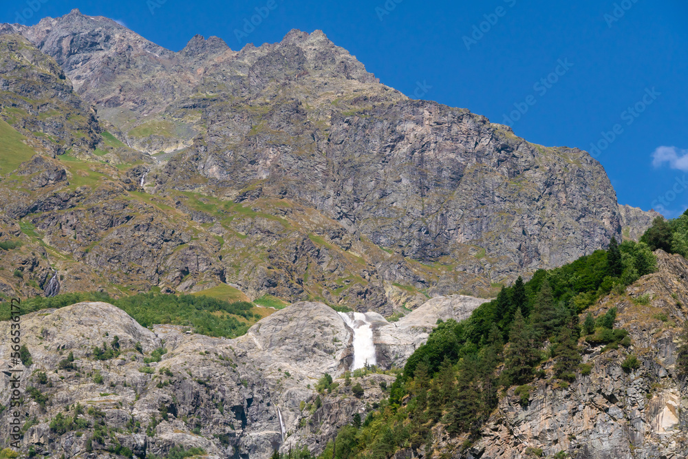 Beautiful mountain landscape with Shdugra waterfall, Mazeri, Svaneti, Georgia on a sunny bright summer day