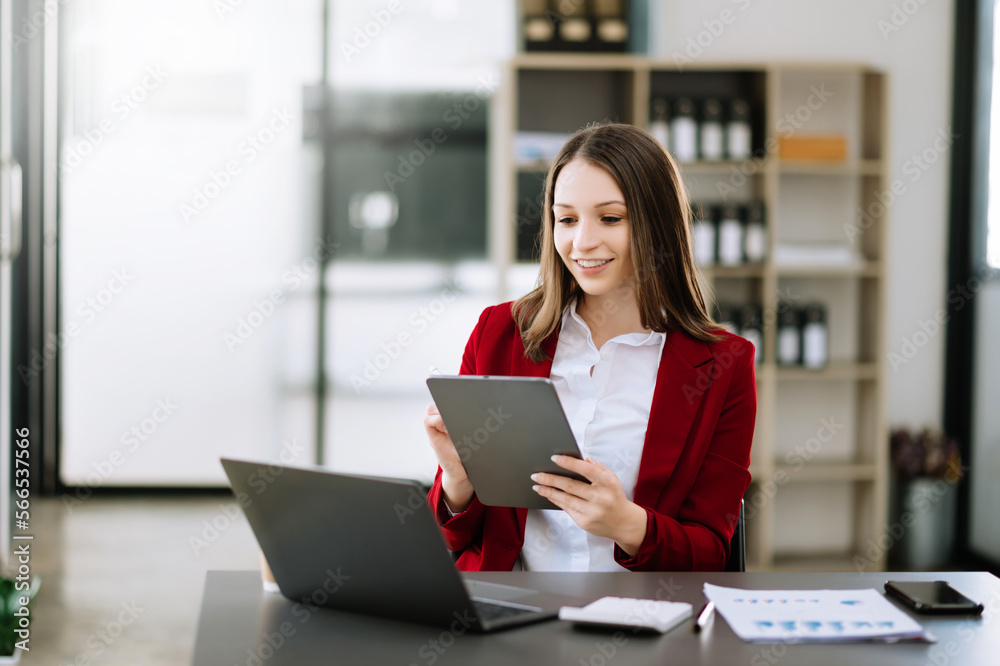 Asian businesswoman working in the office with working notepad, tablet and laptop documents . Asian businesswoman working in the office with working notepad, tablet and laptop documents .