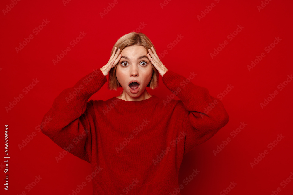 Young blonde woman with short hair screaming and grabbing her head Young blonde woman with short hair screaming and grabbing her head