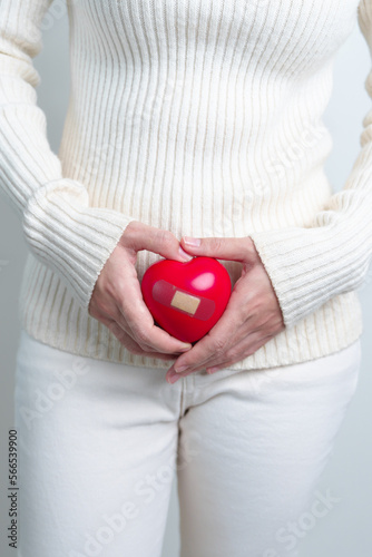 Woman holding  red heart shape. Pregnancy, Reproductive system, menstruation, and gynecology concept photo